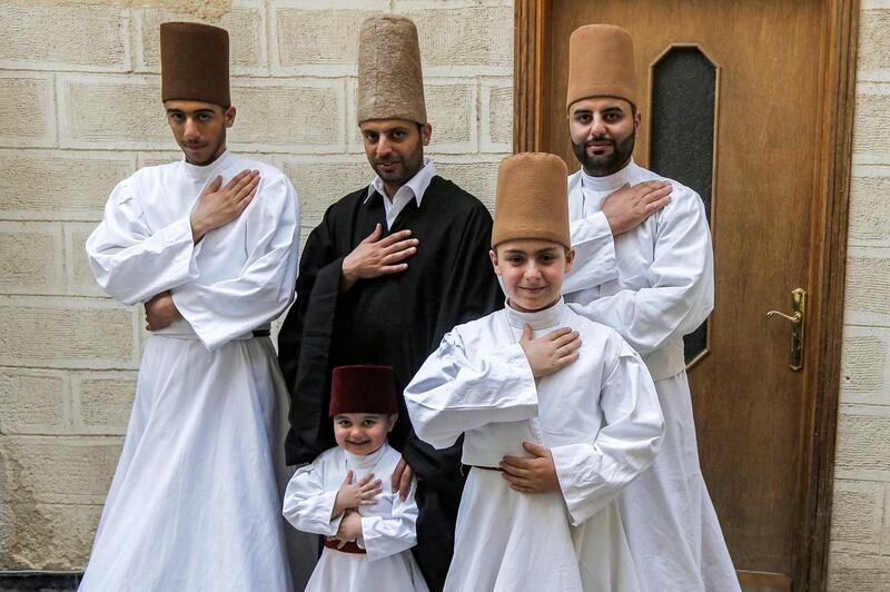Members of the Al Kharrat family pose for a picture in costume at their home.  AFP
