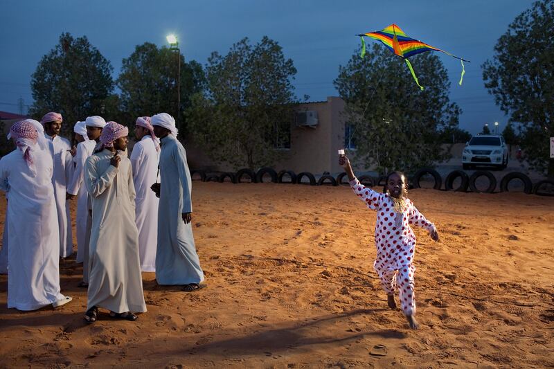 Al Ain, United Arab Emirates, January 30, 2013: 
Eight-year-old Hamda Jummeery runs with her kite as she and other children partake in a Family Day organized for the employees and the foster families of Dar Zayed for Family Care, a state-funded  programme in Al Ain for abandoned, orphaned or neglected children, on Wednesday evening, Jan. 30, 2013, at the Al Bedaa Resort near Al Ain where the organization is based. The children attending Family Day were a mixture of staff children, children who live in Dar Zayed villas and children placed long-term with outside foster families. It is the second time Dar Zayed has held the Family Day event.
Silvia Razgova / The National
