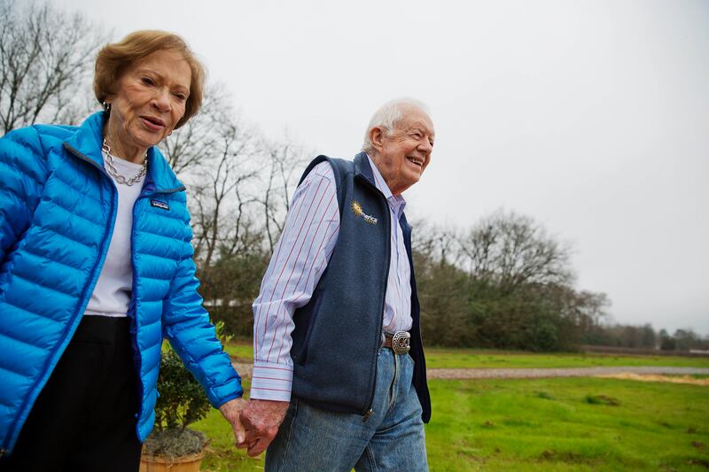 Former president Jimmy Carter and wife Rosalynn arrive for a ribbon-cutting ceremony for a solar panel project in 2017. AP