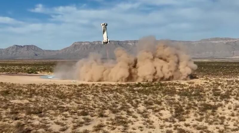 The New Shepard reusable booster lands in a Texan desert after capsule separation. 