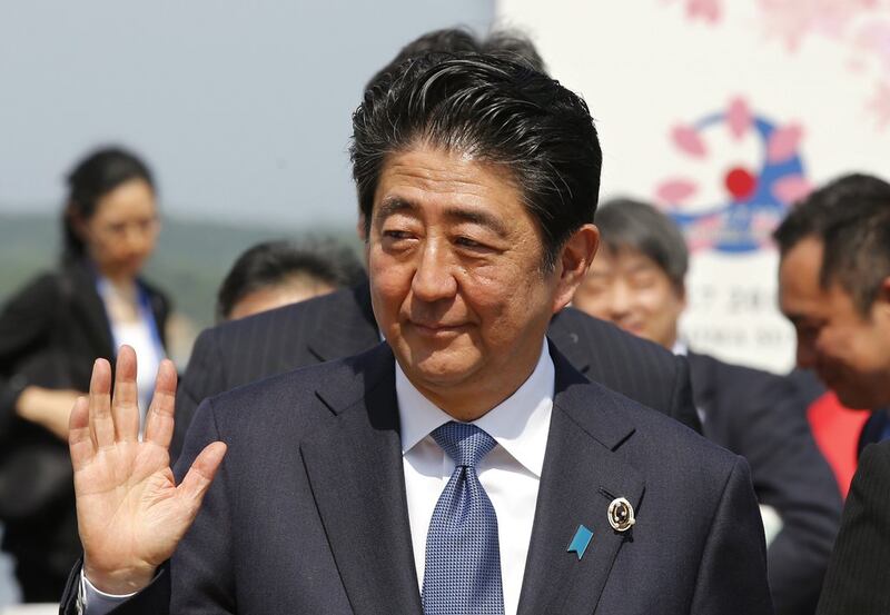 Japanese prime minister Shinzo Abe waves after a press conference of the Group of Seven Summit in Shima, Japan. Shizuo Kambayashi / AP