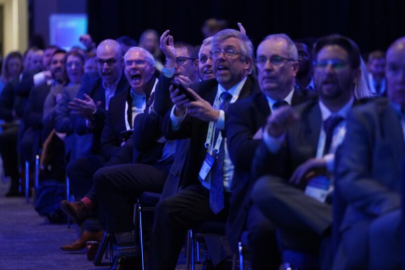 Business figures celebrate as they watch England v Iran on a big screen at the CBI annual conference at the Vox Conference Centre in Birmingham. PA