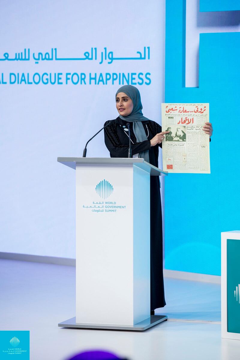 Ohood Al Roumi, Minister of State for Happiness and Wellbeing, holds up a newspaper dated November 11, 1971 with UAE Founding Father Sheikh Zayed's words as the headline: “My wealth is the happiness of my people”. Courtesy World Government Summit