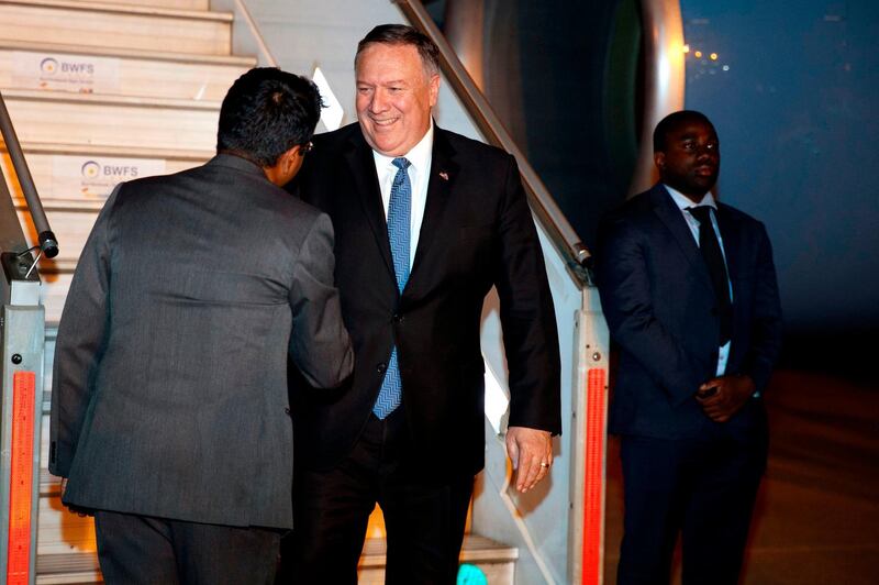 India's Deputy Chief of Protocol Shri Mayank Singh (left) greets US Secretary of State Mike Pompeo upon his arrival in New Delhi.  AFP