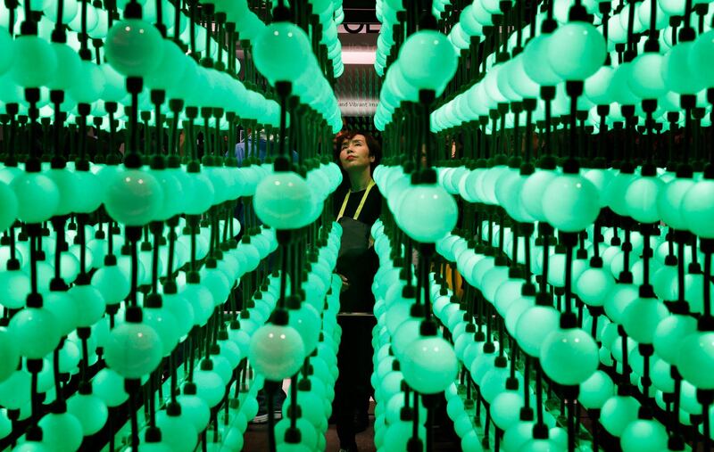 Soyoung Han looks at a display representing LG super UHD TV Nano Cell displays during CES International, Tuesday, Jan. 9, 2018, in Las Vegas. (AP Photo/John Locher)