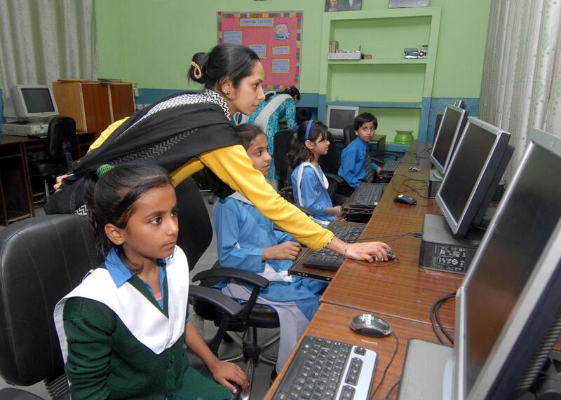 Children learn computer skills at City District Government Middle School, Chah Meeran, Lahore. In 2008, the school had 26 pupils and was on the verge of closing due to dilapidated conditions, lack of teaching staff and poor facilities. It was adopted by Seema Aziz’s Care Foundation and now teaches more than 1,100 pupils. Muzammil Pasha for The National