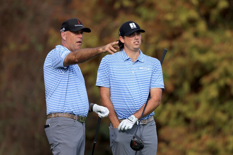 Stewart Cink and Reagan Cink look over a shot on the 18th hole. AFP