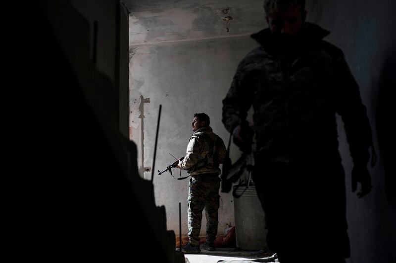 Syrian Democratic Forces fighters shelter in a building as fighting continues in the village of Baghouz. AP Photo