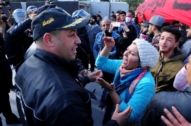 A demonstrator argues with a police officer in Tunis. AP