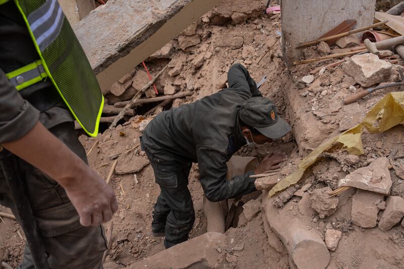 A member of the civil defence searches for bodies in the rubble of a collapsed house in Azgour, Morocco. Getty Images