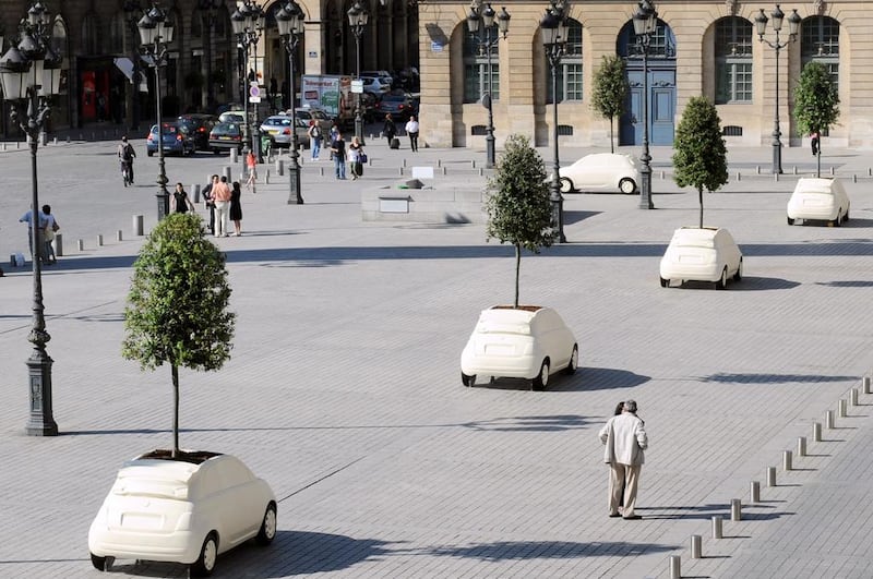 Fibreglass sculptures by the famed architect and designer Fabio Novembre, inspired by the Fiat 500C model and containing a planted tree, at the prestigious Place Vendôme in Paris in a 2010 exhibition. AFP Photo  