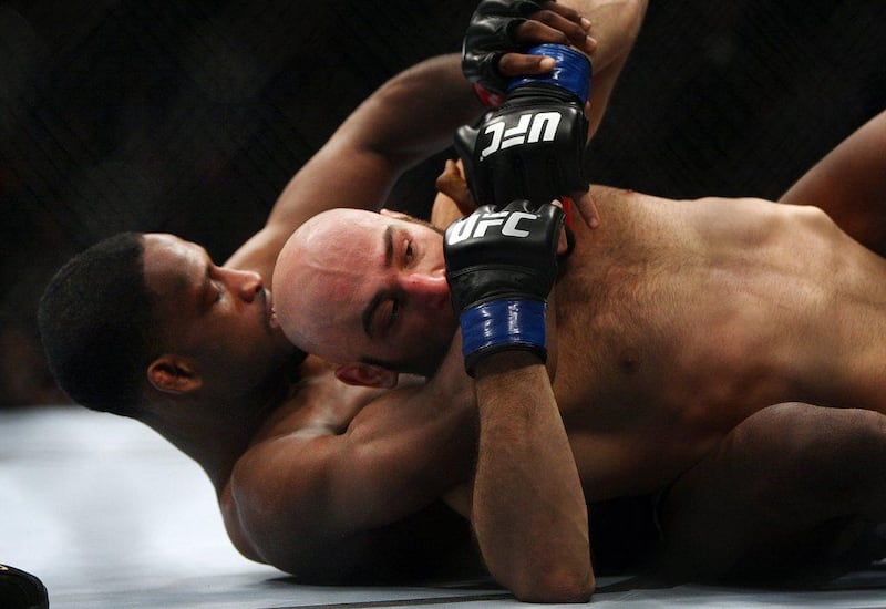 Neil Magny holds onto Gasan Umalatov during their welterweight fight on Saturday. Magny won by unanimous decision. Tim Larsen / AP