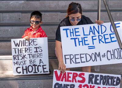 Evelyn Guillen and her three-year-old son join anti-vaccine protesters outside the Los Angeles Unified School District administrative offices in Los Angeles, on September  9. AP