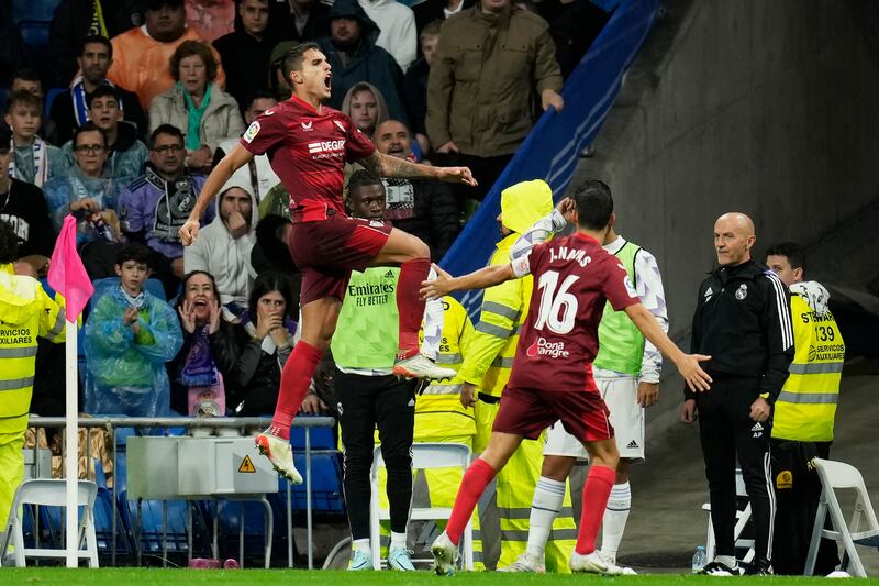 Erik Lamela, left, celebrates after scoring Sevilla's equaliser against Real Madrid. AP