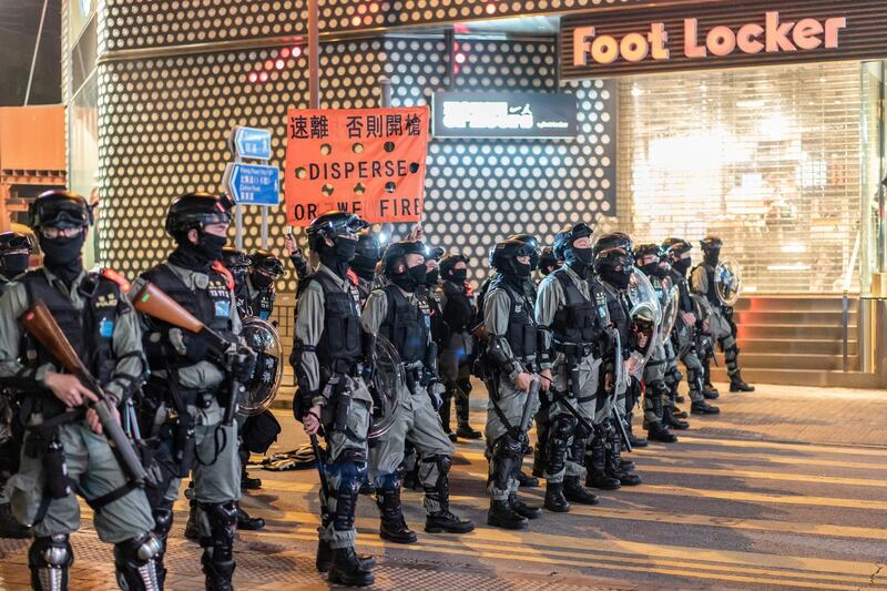 Riot police secure an area as they hold up a warning flag during a standoff with protesters on December 24, 2019 in Hong Kong, China. Anthony Kwan/Getty Images