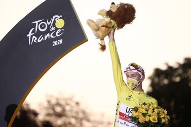 Team UAE Emirates rider Slovenia's Tadej Pogacar wearing the overall leader's yellow jersey celebrates on the podium after winning the 107th edition of the Tour de France cycling race, after the 21st and last stage of 122 km between Mantes-la-Jolie and Champs Elysees Paris, on September 20, 2020. / AFP / KENZO TRIBOUILLARD