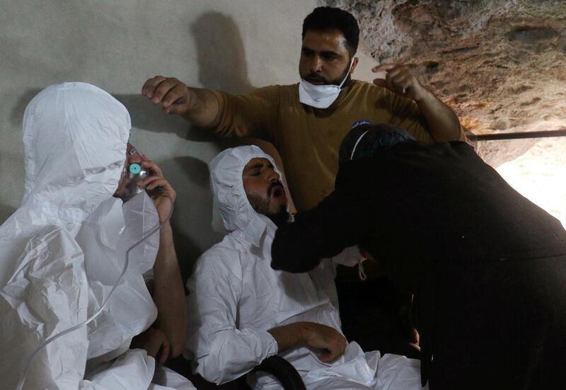 A man breathes through an oxygen mask as another one receives treatments, after what rescue workers described as a suspected gas attack in the town of Khan Sheikhoun in rebel-held Idlib, Syria April 4, 2017. REUTERS/Ammar Abdullah - RC1B0D27C0B0