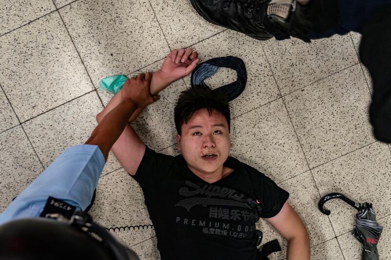 HONG KONG, CHINA - SEPTEMBER 5: A protester is detained by police at Po Lam Station on September 5, 2019 in Hong Kong, China. Pro-democracy protesters have continued demonstrations across Hong Kong since 9 June against a controversial bill which allows extraditions to mainland China, as the ongoing protests, many ending up in violent clashes with the police, have surpassed the Umbrella Movement from five years ago and become the biggest political crisis since Britain handed its onetime colony back to China in 1997. Hong Kong's embattled leader Carrie Lam announced the formal withdrawal of the controversial extradition bill on Wednesday, meeting one of protesters' five demands after 13 weeks of demonstrations. (Photo by Anthony Kwan/Getty Images)