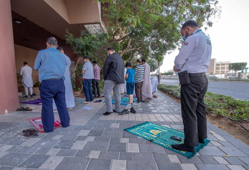 Worshippers during Asr gather outside an already full private Mosque in Zadco Building along Al Khaleej Al Arabi Street in central Abu Dhabi on April 26th, 2021. Victor Besa / The National.