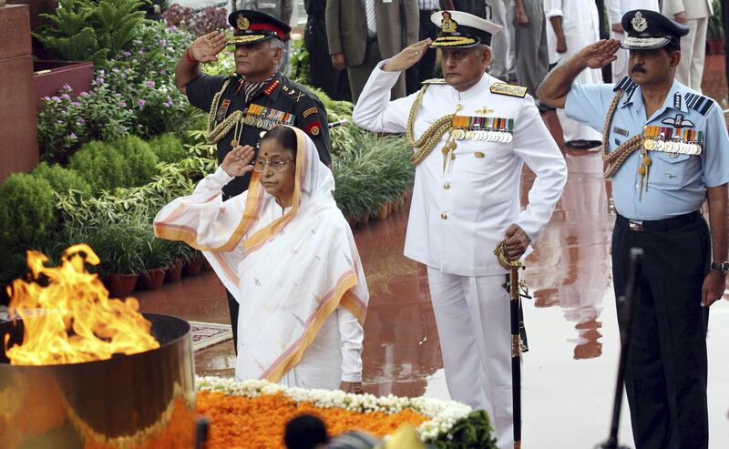 ----EDITORS NOTE---- RESTRICTED TO EDITORIAL USE - MANDATORY CREDIT " AFP PHOTO / HO / MINISTRY OF DEFENCE" - NO MARKETING NO ADVERTISING CAMPAIGNS - DISTRIBUTED AS A SERVICE TO CLIENTS

In this photograph released by the Ministry of Defence, Indian President Pratibha Patil (L) pays her respects at the Amar Jawan Jyoti (Tomb of the Unnamed Soldier) at the India Gate monument during Independence Day in New Delhi on August 15, 2011. India's prime minister used his Independence Day address August 15 to try to reassure the country his government was taking "the strictest possible action" against corruption after a string of scandals. AFP PHOTO/HO/MINISTRY OF DEFENCE
 *** Local Caption ***  614361-01-08.jpg