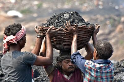 Workers prepare to load coal on to a lorry at the Jharia coalfield in Dhanbad, in India's Jharkhand state. AFP