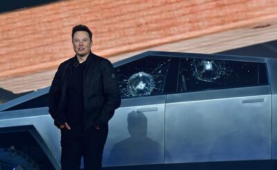 Tesla co-founder and CEO Elon Musk stands in front of the shattered windows of the newly unveiled all-electric battery-powered Tesla's Cybertruck at Tesla Design Center in Hawthorne, California on November 21, 2019.  / AFP / FREDERIC J. BROWN
