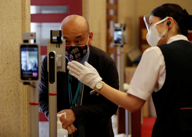 Body temperature checks and hand sanitising procedures are in place at the entrance of the Kabukiza Theatre. Reuters