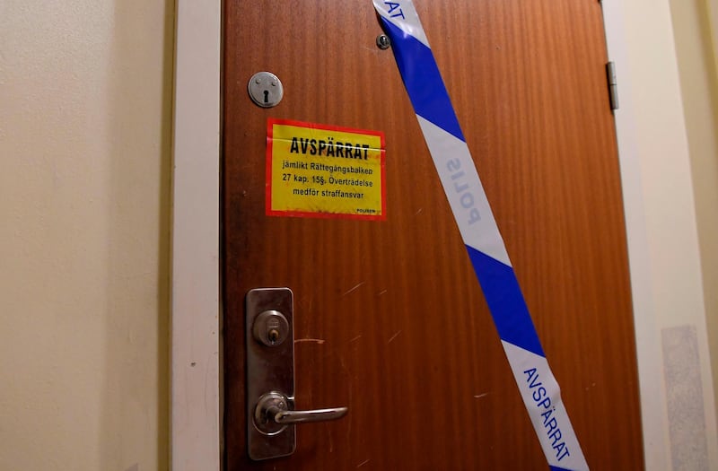 Barrier tape of the police is fixed on the door of an apartment in Haninge, south of Stockholm, on December 1, 2020, one day after a man in his 40s who was kept locked by his mother was found there. A mother in Sweden has been arrested on suspicion of locking her son inside their apartment for 28 years, leaving him undernourished and with almost no teeth, police and media reports said. / AFP / Jonathan NACKSTRAND
