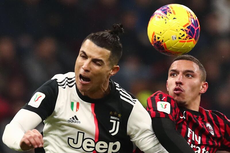 Cristiano Ronaldo beats AC Milan's Ismael Bennacer to a header. AFP