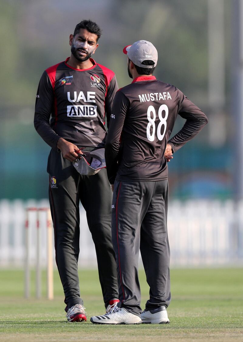 Abu Dhabi, United Arab Emirates - October 22, 2018: Ahmed Raza (L) and captain Rohan Mustafa of the UAE chat in the match between the UAE and Australia in a T20 international. Monday, October 22nd, 2018 at Zayed cricket stadium oval, Abu Dhabi. Chris Whiteoak / The National