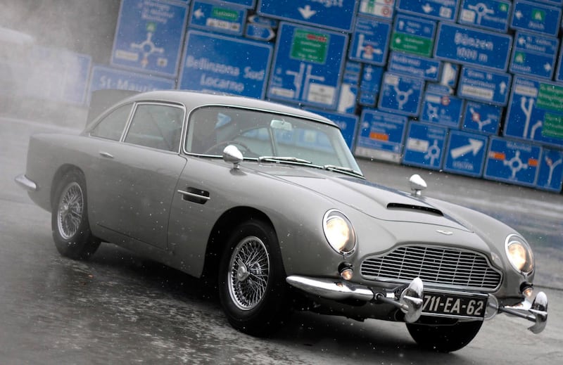 The 1964 Aston Martin DB5, made famous in the James Bond movies "Goldfinger" and "Thunderball" which featured Scottish actor Sean Connery, is displayed for the first time since a total restoration at the Transport Museum in Luzern in this December 10, 2010 file photo. Aston Martin stands at the centre of an international takeover battle after Indian motors group Mahindra trumped an Italian bid for half of the British luxury car maker. Italian private equity fund Investindustrial reached an agreement on November 22, 2012 with the owner, Kuwaiti investment house Investment Dar, but Mahindra and Mahindra made a higher offer on November 23, 2012, leaving the fate of the 98-year old icon of British motor engineering hanging in the balance, sources familiar with the discussions said.  REUTERS/Romina Amato/Files (SWITZERLAND - Tags: SOCIETY TRANSPORT ENTERTAINMENT BUSINESS)