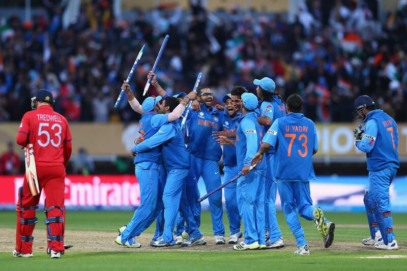 BIRMINGHAM, ENGLAND - JUNE 23:  James Tredwell (L) of England cuts a lonely figure as India players celebrate their 5 run victory during the ICC Champions Trophy Final match between England and India at Edgbaston on June 23, 2013 in Birmingham, England.  (Photo by Michael Steele/Getty Images) *** Local Caption ***  171226998.jpg