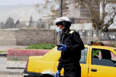 epa08319353 A policeman wearing face mask walks in Damascus, Syria, 24 March 2020. Syrian government introduced measures to prevent the spread of the coronavirus after Syria announced the first case of covid19 on 21 March. Syria imposed a curfew from 6pm to 6am local time as of 24 March, suspended work in the ministries and its affiliated entities until further notice and closed markets and suspend all commercial, service, cultural and social activities. EPA/YOUSSEF BADAWI