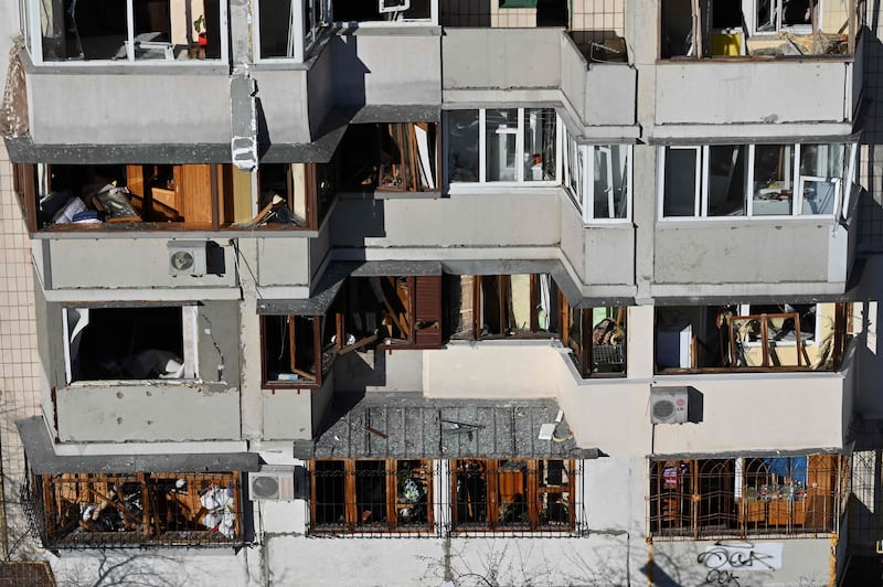 A residential building damaged by a blast wave at the scene where debris from a downed rocket hit a nearby apartment block in Kyiv. AFP