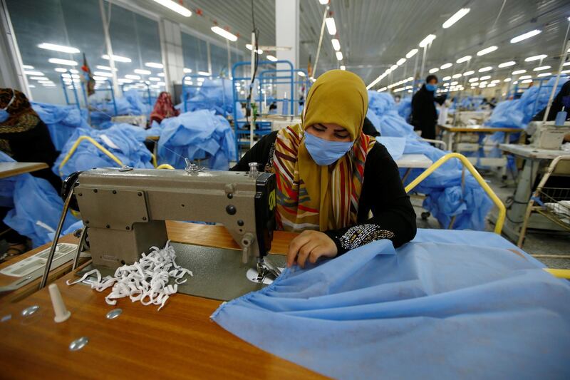 Women sew protective suits, following the outbreak of the coronavirus disease (COVID-19), at a factory in the holy city of Najaf, Iraq June 10, 2020. REUTERS/Alaa Al-Marjani