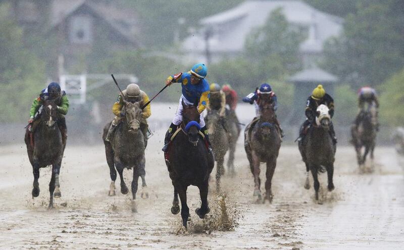 American Pharoah, centre, ridden by Victor Espinoza, wins the 140th Preakness Stakes horse race at Pimlico Race Course on May 16, 2015, in Baltimore. Patrick Semansky / AP Photo