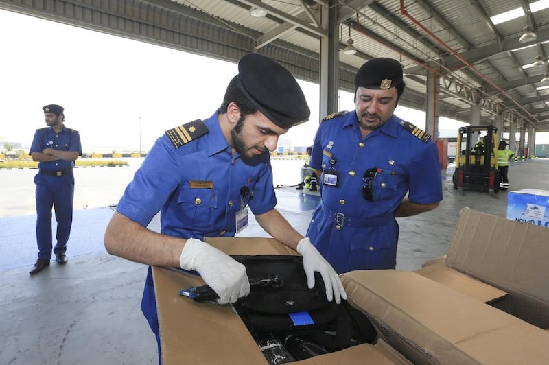 Dubai Customs inspectors swab a shipment to detect explosive residue from a shipment unloaded in Jebel Ali Port. Sarah Dea / The National