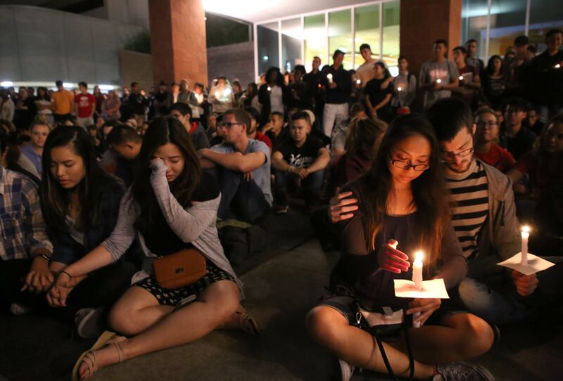 Student mourners console each other during a candlelight vigil at the University of Nevada Las Vegas (UNLV) for victims of the mass shooting in Las Vegas. Eugene Garcia / EPA