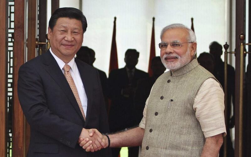 India's prime minister Narendra Modi, right, with the Chinese president Xi Jinping in Ahmadabad, India. Ajit Solanki / AP Photo