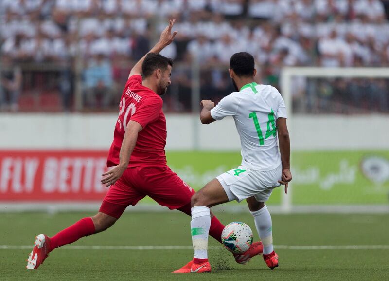 Saudi Arabia's Abdullah Otayf, right challenges Palestine's Nathmi Albadawi during their FIFA World Cup Asian Qualifying Group Four soccer match, at Faisal Husseini Stadium, in the West Bank city of Ramallah. The match ended with a 0-0 draw. AP Photo