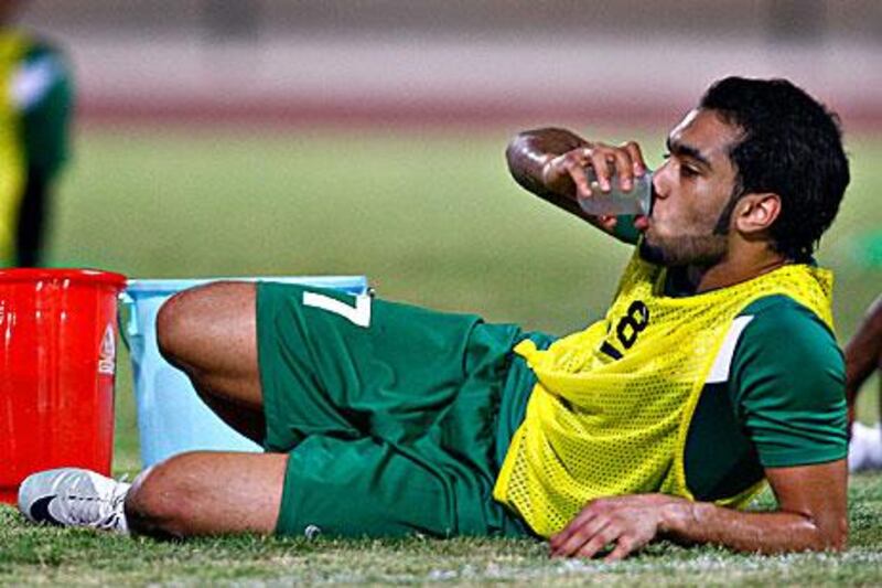 Al Wasl's Mohammad Omar has a drink break during training in the night.