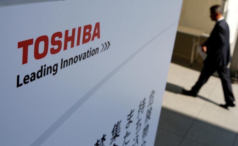 FILE PHOTO: The logo of Toshiba is seen as a shareholder arrives at an extraordinary shareholders meeting in Chiba, Japan, March 30, 2017. REUTERS/Toru Hanai/File Photo