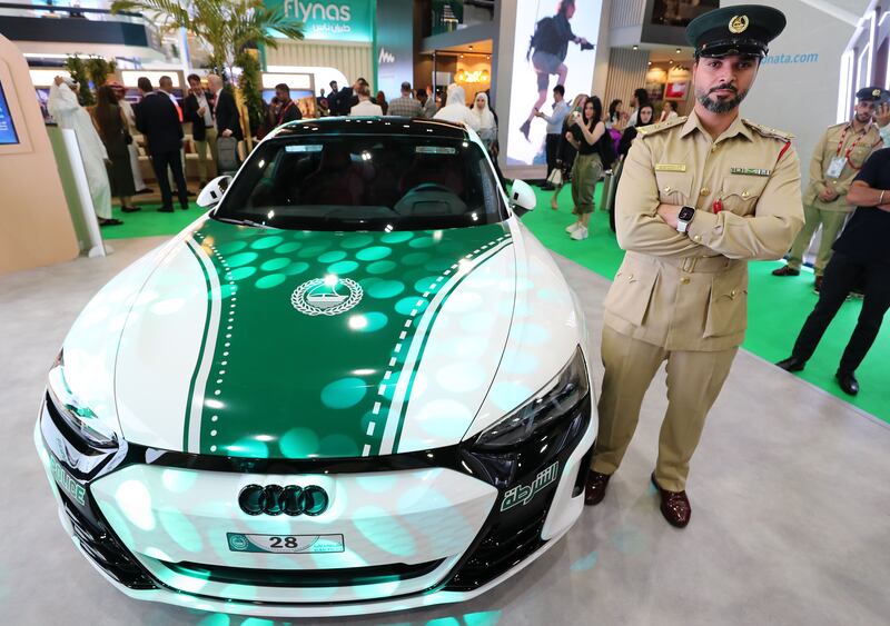 First lieutenant Mohamed Ebrahim Al Suwaidi with the new Dubai Police car an Audi RS e-trom GT, the force's first electric sports car. Chris Whiteoak / The National