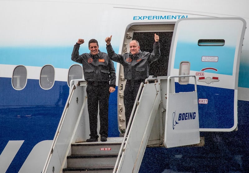 Boeing 777X chief test pilot Van Chaney, right, and co-pilot Craig Bomben, Boeing's VP Flight operations and chief test pilot, emerge from the 777X after landing at Boeing Field in Seattle.  AP