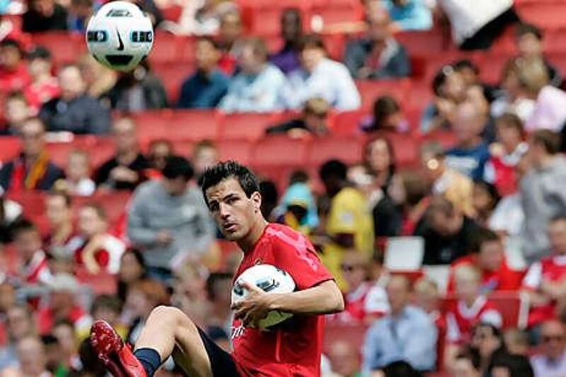 Cesc Fabregas, shown at an open training session this week at the Emirates Stadium, says he is staying at Arsenal.