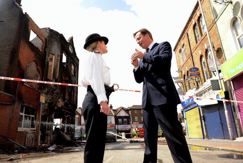 Then prime minister David Cameron talks to Jo Oakley, acting borough commander superintendent, during a visit to Croydon to view the destruction.
