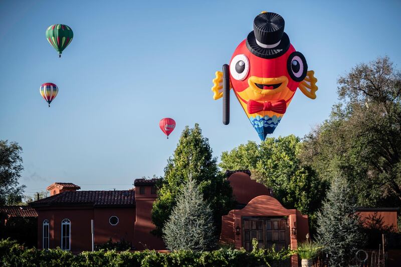 Hot air balloons drift over the village of Corrales, New Mexico. AP Photo