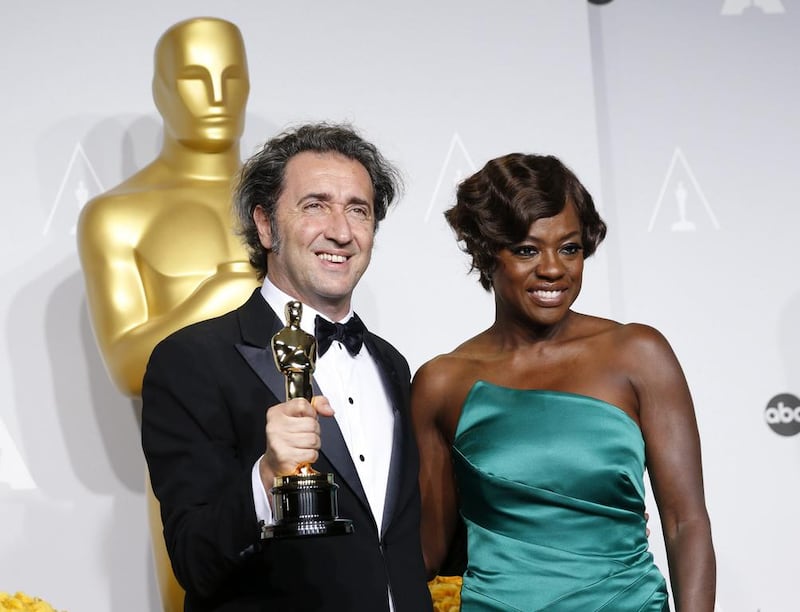 Paolo Sorrentino, director of Italian film The Great Beauty poses with his award for best foreign language film with presenter Viola Davis. Reuters 
