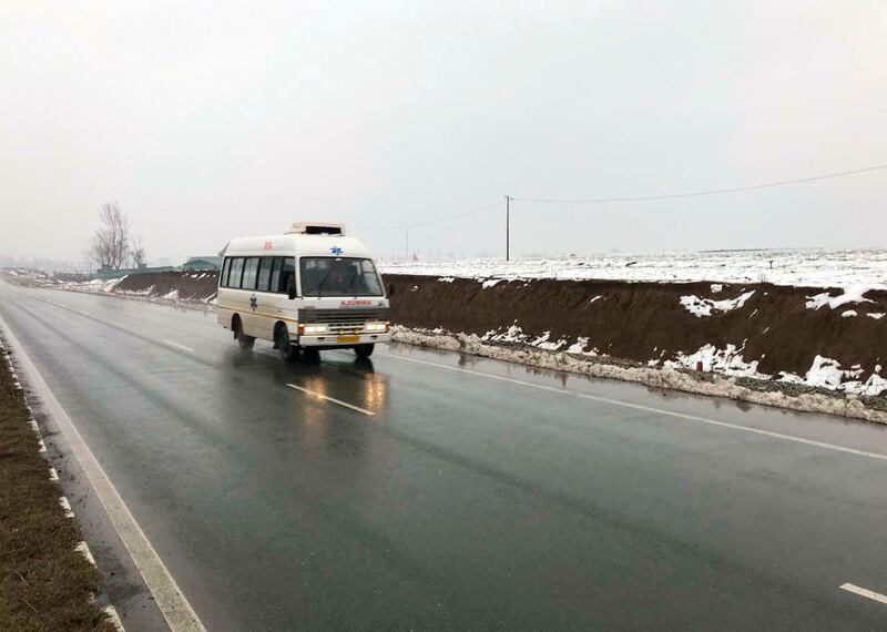 An ambulance drives on a highway, traveling from the direction of a large explosion, in Pampore, Indian-controlled Kashmir, Thursday, Feb. 14, 2019. Security officials say at least 10 soldiers have been killed and 20 others wounded by a large explosion that struck a paramilitary convoy on a key highway  on the outskirts of the disputed region's main city of Srinagar. (AP Photo/Dar Yasin)