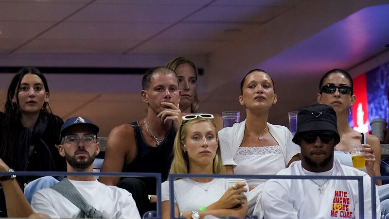 Model Bella Hadid, top second from right, and NFL star Saquon Barkley, bottom right, at the US Open on Friday. AP
